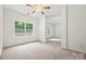 Well-lit main bedroom featuring neutral carpet, large window and recessed tray ceiling at 8120 Calistoga Ln, Waxhaw, NC 28173