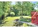 Lush backyard featuring a fire pit, deck, and mature trees for private relaxation and outdoor gatherings at 8200 Park Vista Cir, Charlotte, NC 28226