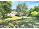 Large backyard featuring a deck, mature trees, and grassy space, perfect for enjoying the outdoors at 8200 Park Vista Cir, Charlotte, NC 28226