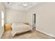 Bedroom featuring a tray ceiling, neutral decor, and a cozy bed with matching nightstands at 8200 Park Vista Cir, Charlotte, NC 28226