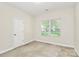Neutral bedroom featuring a large window, plush carpet, and ample closet space at 8200 Park Vista Cir, Charlotte, NC 28226