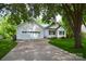 Bright white exterior featuring an attached two-car garage, long driveway, and lush green surroundings at 8200 Park Vista Cir, Charlotte, NC 28226