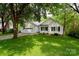 Charming white home with a well-manicured lawn and mature trees, providing shade and curb appeal at 8200 Park Vista Cir, Charlotte, NC 28226
