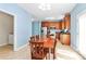 Bright eat-in kitchen with wood cabinetry, stainless steel appliances, and adjacent laundry room at 8200 Park Vista Cir, Charlotte, NC 28226
