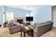Comfortable living room featuring a fireplace, ceiling fan, and neutral-toned furniture for a relaxing ambiance at 8200 Park Vista Cir, Charlotte, NC 28226