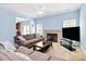 Relaxing living room with a fireplace and comfortable seating under a cooling ceiling fan at 8200 Park Vista Cir, Charlotte, NC 28226