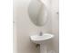 Small, simple bathroom featuring pedestal sink, faucet, round mirror, and towel ring at 827 Gentlewinds Ct, Fort Mill, SC 29708