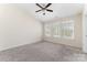 Bright bedroom features a ceiling fan and three windows, providing ample natural light at 827 Gentlewinds Ct, Fort Mill, SC 29708