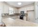Well-lit kitchen has stainless appliances, tiled backsplash, and ample counter space for food preparation at 827 Gentlewinds Ct, Fort Mill, SC 29708