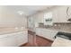 Bright kitchen shows a breakfast bar and stainless sink, plus a back door leading outside at 827 Gentlewinds Ct, Fort Mill, SC 29708