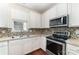 Well-equipped kitchen featuring stainless steel appliances and tiled backsplash at 827 Gentlewinds Ct, Fort Mill, SC 29708