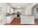 Bright kitchen with white cabinets, stainless steel appliances, and breakfast bar at 827 Gentlewinds Ct, Fort Mill, SC 29708