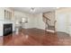 Open-concept living room boasts a fireplace, hardwood floors, and staircase at 827 Gentlewinds Ct, Fort Mill, SC 29708