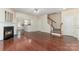 Bright living room features hardwood floors, a fireplace, and open access to the staircase at 827 Gentlewinds Ct, Fort Mill, SC 29708