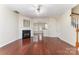 Open living space features hardwood floors, fireplace, with an archway leading into the kitchen at 827 Gentlewinds Ct, Fort Mill, SC 29708