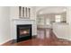 Inviting living room featuring a fireplace, seamless flow into the dining, and modern kitchen at 827 Gentlewinds Ct, Fort Mill, SC 29708