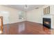 Open living room featuring hardwood floors, fireplace, and plenty of natural light at 827 Gentlewinds Ct, Fort Mill, SC 29708