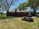 Backyard exterior featuring a stone picnic table, driveway, and garage at 8588 Smith Rd, Kannapolis, NC 28081