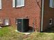 Exterior of the brick home with an HVAC unit and white trimmed windows at 8588 Smith Rd, Kannapolis, NC 28081