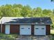 Exterior of the detached two car garage with white doors at 8588 Smith Rd, Kannapolis, NC 28081