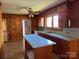Cozy kitchen featuring wood cabinetry, a center island, and ample natural light at 8588 Smith Rd, Kannapolis, NC 28081
