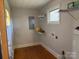 Functional laundry room with shelving and natural light at 8588 Smith Rd, Kannapolis, NC 28081