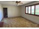 Bright living room featuring multiple windows and tan carpeted floors at 8588 Smith Rd, Kannapolis, NC 28081