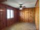 Inviting living room with classic wood walls and abundant natural light at 8588 Smith Rd, Kannapolis, NC 28081