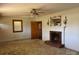 Spacious living room featuring a classic fireplace and neutral-toned carpet at 8588 Smith Rd, Kannapolis, NC 28081