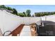 Enclosed backyard with a white fence, walkway, and seating area offers a private and serene outdoor space at 8814 Gerren Ct, Charlotte, NC 28217