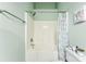Bright bathroom featuring a shower-tub combo with white tile, modern fixtures, and a stylish patterned shower curtain at 8814 Gerren Ct, Charlotte, NC 28217