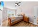 Bedroom with ceiling fan and ample natural light from large window at 8814 Gerren Ct, Charlotte, NC 28217