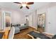 Versatile bedroom featuring a comfy couch, hardwood flooring, and an ensuite bathroom for convenience and relaxation at 8814 Gerren Ct, Charlotte, NC 28217