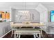 Cozy dining area featuring a modern light fixture, table setting, and neutral décor at 8814 Gerren Ct, Charlotte, NC 28217