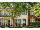 Charming townhouse with a well-maintained front yard, beautiful landscaping, and a welcoming entrance with blue shutters at 8814 Gerren Ct, Charlotte, NC 28217
