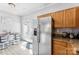 Eat-in kitchen features stainless steel fridge and access to backyard at 8814 Gerren Ct, Charlotte, NC 28217
