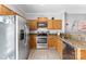 Well-lit kitchen featuring stainless steel appliances, granite countertops, and wood cabinets at 8814 Gerren Ct, Charlotte, NC 28217