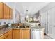 Kitchen sink area boasting granite countertops, stainless steel dishwasher, and view to living room at 8814 Gerren Ct, Charlotte, NC 28217