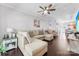 Spacious living room featuring a large sectional sofa, ceiling fan, and wood flooring at 8814 Gerren Ct, Charlotte, NC 28217