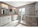 Modern bathroom features double sinks, white cabinets, and a tiled walk-in shower at 900 Springwood Dr, Waxhaw, NC 28173
