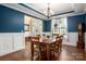 Formal dining room with hardwood floors, chandelier, and blue accent wall at 900 Springwood Dr, Waxhaw, NC 28173