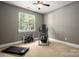 Carpeted exercise room with fitness equipment and natural light from one window at 900 Springwood Dr, Waxhaw, NC 28173