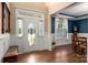 Bright foyer with hardwood floors, decorative door with sidelights and adjacent dining room at 900 Springwood Dr, Waxhaw, NC 28173