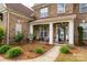 Inviting front porch with decorative accents, seating, and manicured garden beds at 900 Springwood Dr, Waxhaw, NC 28173