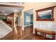 Open hallway with hardwood floors, stairway and decorative mirror with coat hooks at 900 Springwood Dr, Waxhaw, NC 28173