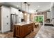 Spacious kitchen featuring white cabinets, a stainless steel refrigerator, and a large wooden center island at 900 Springwood Dr, Waxhaw, NC 28173