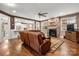 Spacious living room features a stone fireplace, hardwood floors, and leather seating at 900 Springwood Dr, Waxhaw, NC 28173