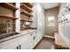 Well-organized mud room with custom cabinets, wooden shelves, and convenient sink at 900 Springwood Dr, Waxhaw, NC 28173
