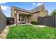 Backyard with green grass, outdoor seating on covered patio, and privacy fence at 9319 Highclere Ct, Matthews, NC 28105