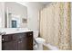 Bathroom with a dark vanity, tile floors, and shower with floral curtain at 9319 Highclere Ct, Matthews, NC 28105